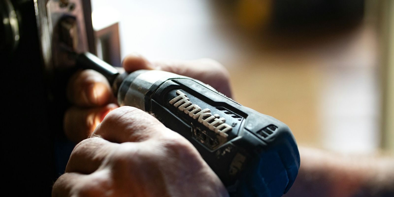 selective focus photography blue and black Makita power drill